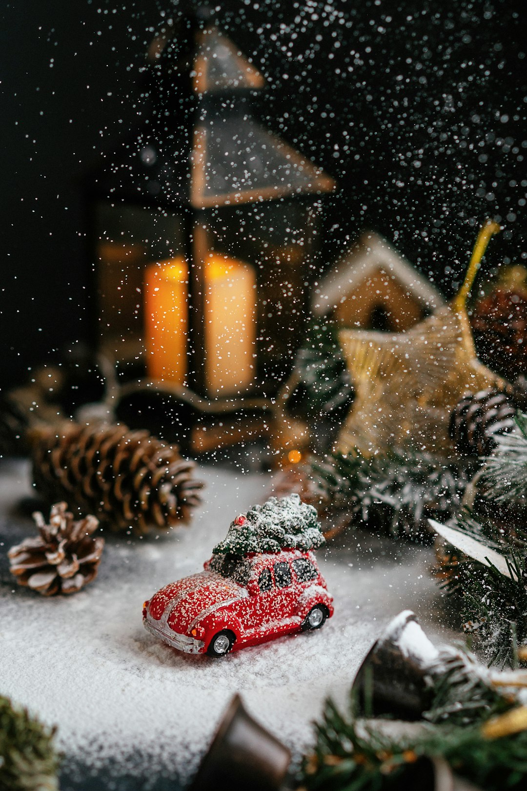 Photo by Kate Laine a red toy car sitting on top of a snow covered ground